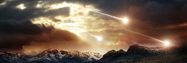 A cloudy sky over a mountain range, illuminated by three falling meteors.